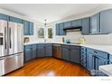 This updated kitchen features painted cabinets, stainless appliances, and quartz countertops at 4312 Black Cherry Ct, Boulder, CO 80301