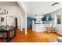 Open floor plan with breakfast bar overlooking the dining area and abundant natural light at 4312 Black Cherry Ct, Boulder, CO 80301