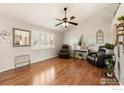 Inviting living room featuring hardwood floors, vaulted ceilings, and large windows for natural light at 5411 E 128Th Dr, Thornton, CO 80241