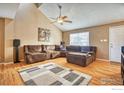 Cozy living room featuring a large sectional sofa, an area rug, and a vaulted ceiling with a ceiling fan at 6140 Ralston St, Frederick, CO 80530