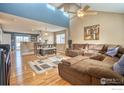 Spacious living room featuring a vaulted ceiling, hardwood floors, and a comfortable sectional sofa at 6140 Ralston St, Frederick, CO 80530