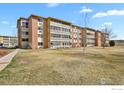 Spacious lawn area surrounding the condo building with mature landscaping at 665 S Alton Way # 12A, Denver, CO 80247