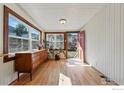 Bright sun room with hardwood floors and mountain views through large windows at 819 9Th St, Boulder, CO 80302