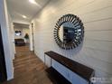 Welcoming hallway featuring wood floors, decorative mirror, console table, and an inviting view into the living space at 841 Gold Hill Dr, Erie, CO 80516