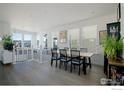 Elegant dining room featuring hardwood floors, modern furnishings, and ample natural light at 841 Hearteye Trl, Lafayette, CO 80026