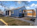 Home exterior with covered patio, showcasing neat landscaping at 895 Oswego St, Aurora, CO 80010