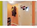 Functional entryway featuring a coat rack, shoe storage, and wall art at 1113 Collyer St, Longmont, CO 80501