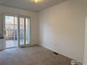 Carpeted bedroom with double glass doors and light interior at 1339 Sumner St # B, Longmont, CO 80501