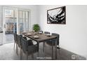 Modern dining room featuring sleek table, seating for eight, and natural light from the door at 1339 Sumner St # B, Longmont, CO 80501