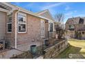 Brick facade entrance featuring a gated entryway with a small garden bed at 1470 S Quebec Way # 234, Denver, CO 80231