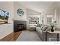 Inviting living room with a modern fireplace, a plush gray sectional, and ample natural light at 1470 S Quebec Way # 234, Denver, CO 80231