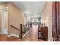 Elegant entryway showcasing hardwood floors, wrought iron railings, and inviting access to the living area at 1614 Hideaway Ct, Longmont, CO 80503