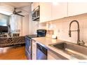 Bright kitchen featuring modern appliances, white cabinets, and an open layout at 1800 Pearl St # 12, Boulder, CO 80302