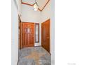 Inviting foyer features tile flooring, a stylish light fixture, and a solid wood door at 2275 E 129Th Ave, Thornton, CO 80241