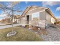 Landscaped yard with rock features surrounding the base of a young tree at 2342 Spotswood St, Longmont, CO 80504