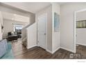 Inviting foyer with hardwood floors that leads into a comfortable living area at 2405 Horse Shoe Cir, Fort Lupton, CO 80621