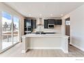 Modern kitchen featuring a large island, stainless appliances, and sliding doors at 3013 South Flat Cir, Longmont, CO 80503