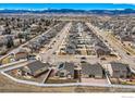 Wide aerial view showcasing houses neatly placed and separated by fences with a backdrop of mountains at 3318 Auklet Dr, Berthoud, CO 80513