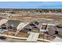 Aerial view of home showing solar panels, large backyard, patio, driveway, and proximity to nearby roads at 3318 Auklet Dr, Berthoud, CO 80513