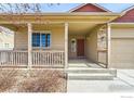 Inviting covered front porch with stone accents, offering shade and a welcoming entrance to the home at 3318 Auklet Dr, Berthoud, CO 80513