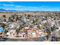 Overhead view shows a house in a neighborhood, mountains in the distance, and a beautiful blue sky at 339 S Hoover Ave, Louisville, CO 80027