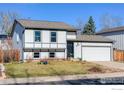 Charming two-story home features a manicured lawn, two-car garage, and stylish white and grey trim at 339 S Hoover Ave, Louisville, CO 80027