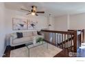 Cozy loft area with stylish furnishings, modern lighting, and an open staircase at 339 S Hoover Ave, Louisville, CO 80027