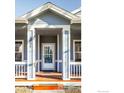 Inviting front porch featuring white pillars and wooden decking at 4004 Ravenna Pl, Longmont, CO 80503