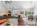 Open-concept living room with a fireplace, bay window, and seamless flow to the dining area at 4475 Laguna Pl # 309, Boulder, CO 80303