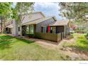 A view of the back yard and exterior of the home with a patio area at 4996 Clubhouse Cir, Boulder, CO 80301