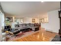 Spacious living room with hardwood floors and a large sectional couch at 4996 Clubhouse Cir, Boulder, CO 80301