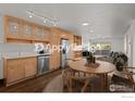 Bright kitchen features wood cabinets, stainless steel appliances, a dining area, and access to the outdoor patio at 500 Mohawk Dr # 510, Boulder, CO 80303