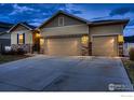 Street view of a single Gathering home with a 3 car garage at 5396 Neighbors Pkwy, Firestone, CO 80504