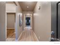 Inviting hallway with a view to the living room and bedrooms at 5396 Neighbors Pkwy, Firestone, CO 80504