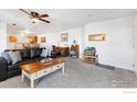 Spacious living room featuring carpet, a ceiling fan, and plenty of natural light at 5425 County Road 32 # 27, Mead, CO 80504