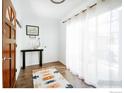 Bright entryway featuring wood floors, an accent rug, and natural light from the windows at 6833 S Buffalo St, Littleton, CO 80120