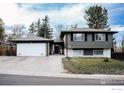 Charming two-story home with a well-maintained front yard and detached garage at 6833 S Buffalo St, Littleton, CO 80120