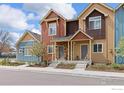 Attractive townhome exterior with colorful facade, stone accents, and charming landscaping at 1317 Country Ct # B, Longmont, CO 80501