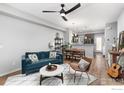 Bright living room with hardwood floors, modern ceiling fan, and open floor plan at 1317 Country Ct # B, Longmont, CO 80501