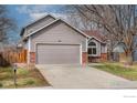 View of the front home exterior displaying a two-car garage, driveway and mailbox at 1624 Foster Dr, Longmont, CO 80501