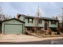 Split level home with attached garage, featuring light green siding, updated windows, and solar panels at 1805 Del Rosa Ct, Boulder, CO 80304