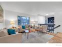 Inviting living room with large window and views to staircase with built-in shelving at 1805 Del Rosa Ct, Boulder, CO 80304