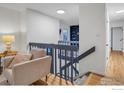 Bright staircase landing area with views into the living room with built-in shelving at 1805 Del Rosa Ct, Boulder, CO 80304