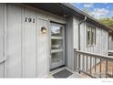 Close up of front door with sidelight, house number and covered porch at 191 Alder Ln, Boulder, CO 80304