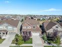 Two-story home boasts an expansive lawn and two-car garage in a peaceful neighborhood at 2310 Provenance St, Longmont, CO 80504