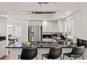 Modern kitchen featuring stainless steel appliances, black countertops, and a breakfast bar at 2471 Norwood Ave, Boulder, CO 80304