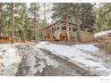 Charming home with a mix of greenery and snow-covered landscapes at 30690 Highway 72, Golden, CO 80403