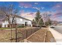 The exterior view of a well-maintained two-story home in a desirable neighborhood showcasing its well-kept yard at 4120 Aurora Ave, Boulder, CO 80303