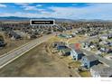 Aerial view of a residential community with a community pool and mountain views at 655 Lene Ln, Berthoud, CO 80513