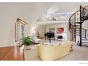 Bright and airy living room featuring a grand piano, spiral staircase, and loft at 6611 Lakeview Dr, Boulder, CO 80303